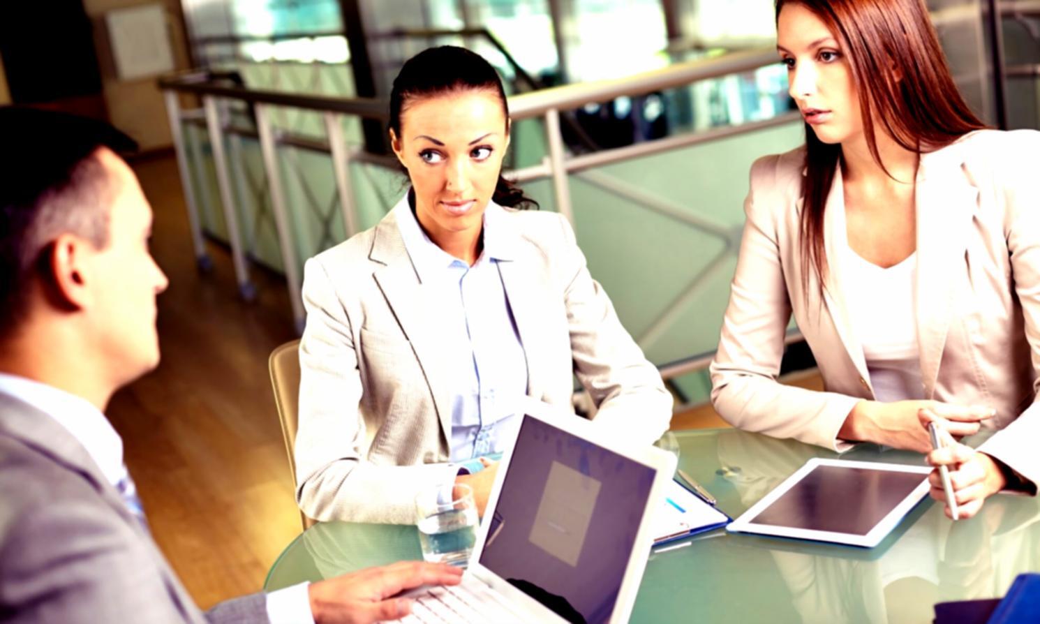 Finance professionals reviewing budget reports and analyzing data trends